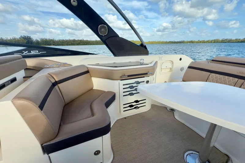 Slide: The Image of Luxurious 2017 Sea Ray SLX 310 Outboard boat interior with seating and table on a sunny day. - 26