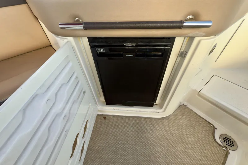 Slide: The Image of 2017 Sea Ray SLX 310 Outboard interior with built-in mini fridge. - 28