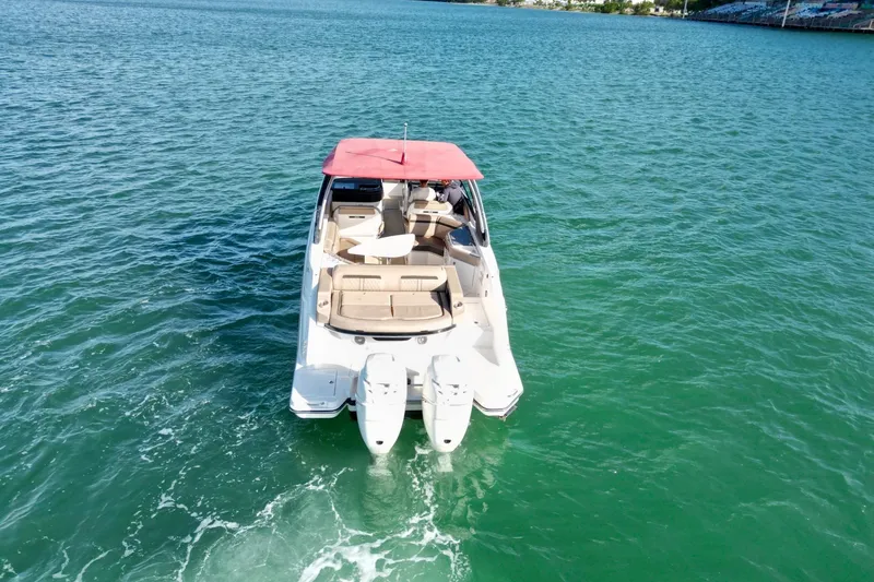 Slide: The Image of 2017 Sea Ray SLX 310 Outboard cruising on clear blue water. - 3