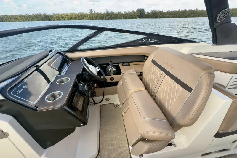 Slide: The Image of 2017 Sea Ray SLX 310 Outboard helm with luxurious seating and modern controls. - 33