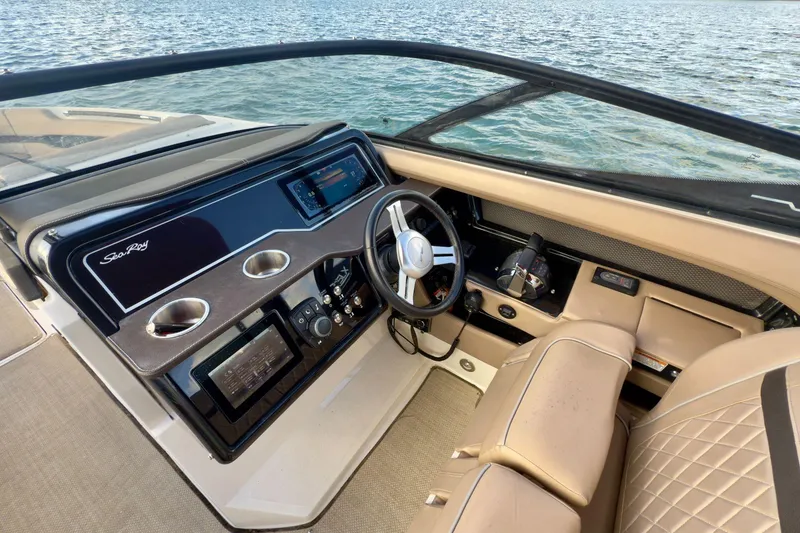 Slide: The Image of 2017 Sea Ray SLX 310 Outboard helm with luxurious seating and advanced controls. - 34