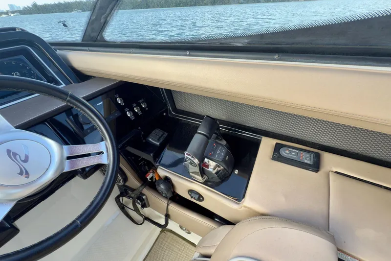 Slide: The Image of 2017 Sea Ray SLX 310 Outboard helm with steering wheel and control panel. - 36