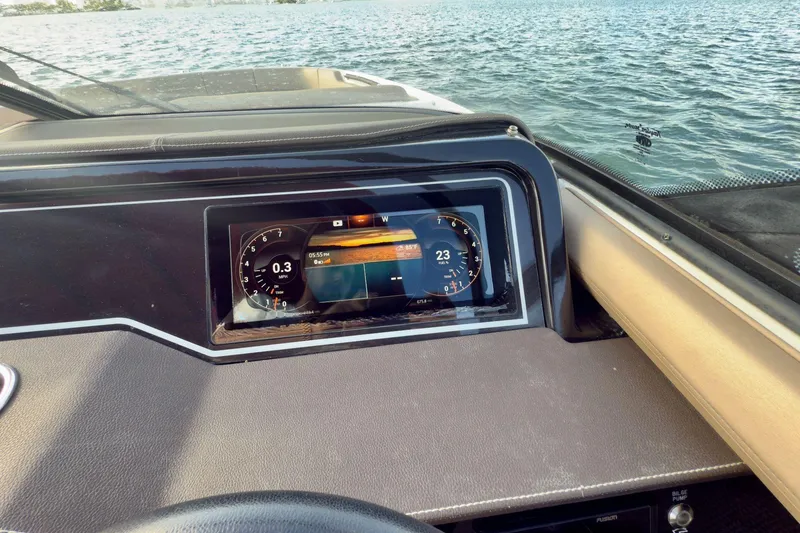 Slide: The Image of Dashboard of a 2017 Sea Ray SLX 310 Outboard boat on water. - 38