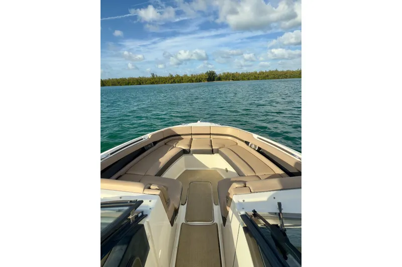 Slide: The Image of 2017 Sea Ray SLX 310 Outboard boat on calm water with clear skies. - 41