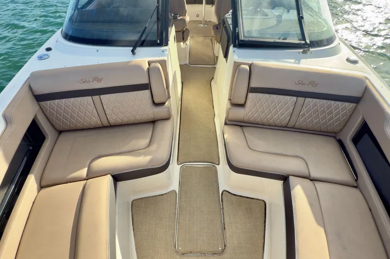 Slide: The Image of 2017 Sea Ray SLX 310 Outboard boat interior with beige seating and elegant design. - 43