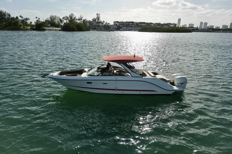 Slide: The Image of 2017 Sea Ray SLX 310 Outboard boat on calm water with scenic background. - 5