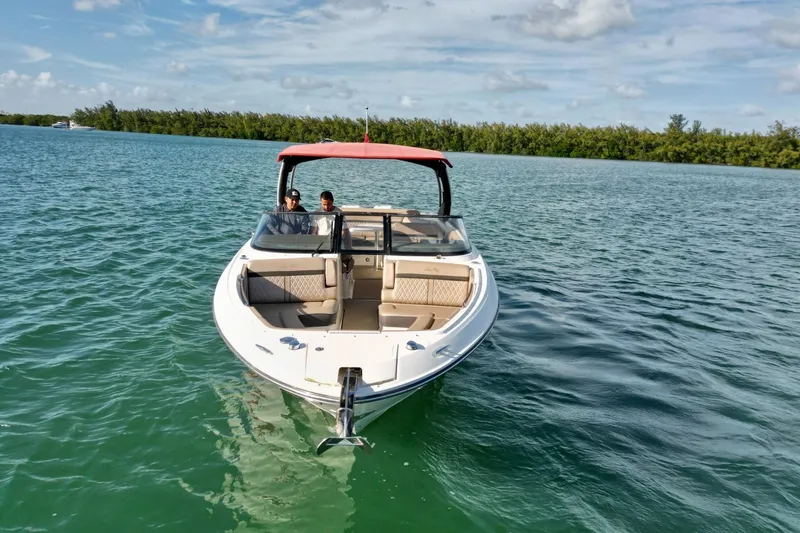Slide: The Image of 2017 Sea Ray SLX 310 Outboard cruising on calm waters under a clear sky. - 8