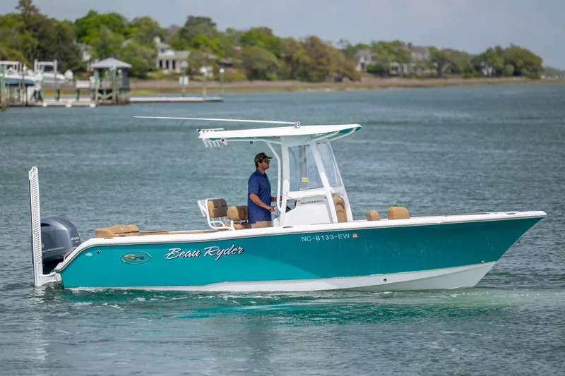 The Image of 2022 Sea Hunt Ultra 234 boat cruising on a calm waterway. - 0