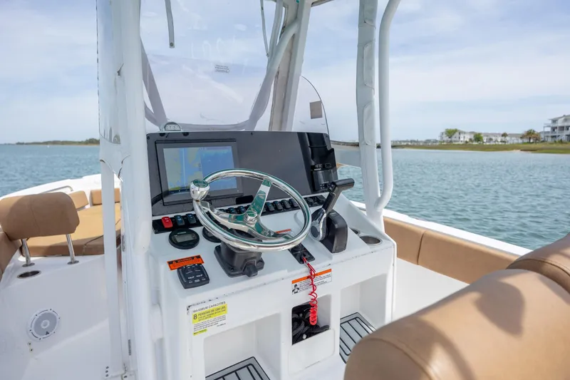 Slide: The Image of 2022 Sea Hunt Ultra 234 boat console with steering wheel and navigation display. - 11