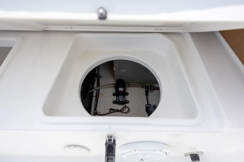 Slide: The Image of 2022 Sea Hunt Ultra 234 boat compartment with visible wiring and components. - 14