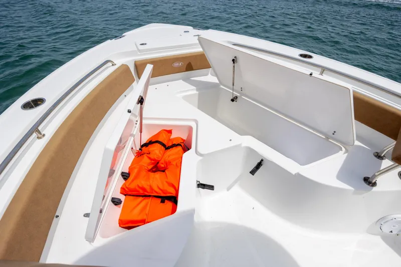 Slide: The Image of 2022 Sea Hunt Ultra 234 boat with open storage compartments and life jackets. - 18