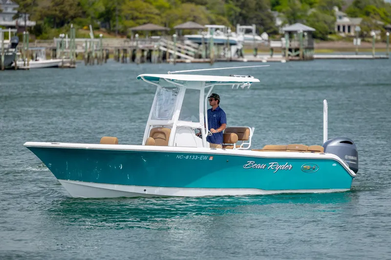 Slide: The Image of 2022 Sea Hunt Ultra 234 boat cruising on a calm waterway. - 3