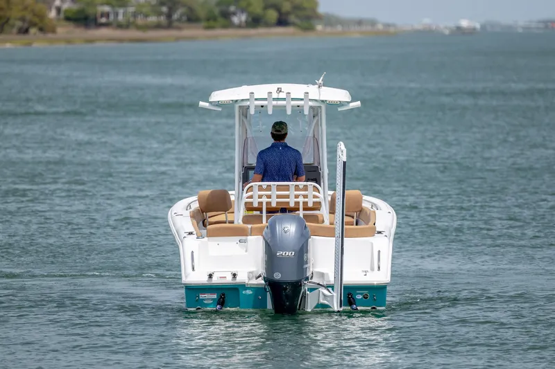 Slide: The Image of 2022 Sea Hunt Ultra 234 boat cruising on a calm waterway. - 5