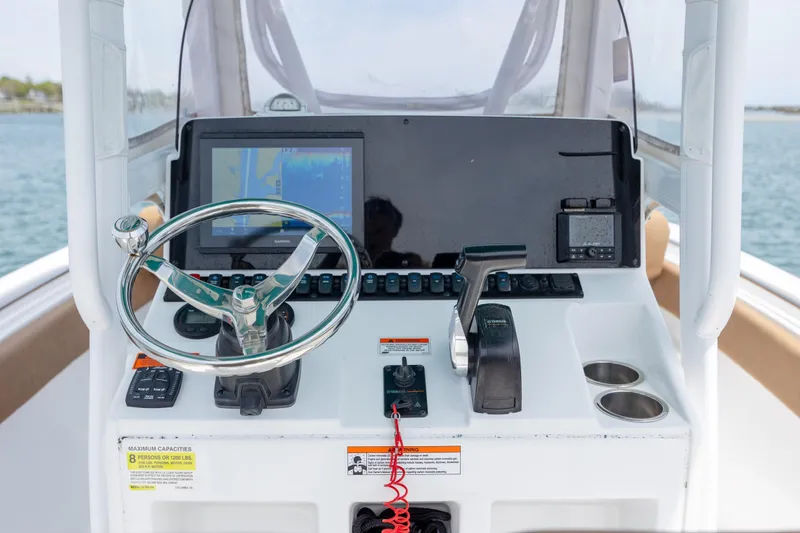 Slide: The Image of Steering console of 2022 Sea Hunt Ultra 234 boat with navigation equipment. - 9