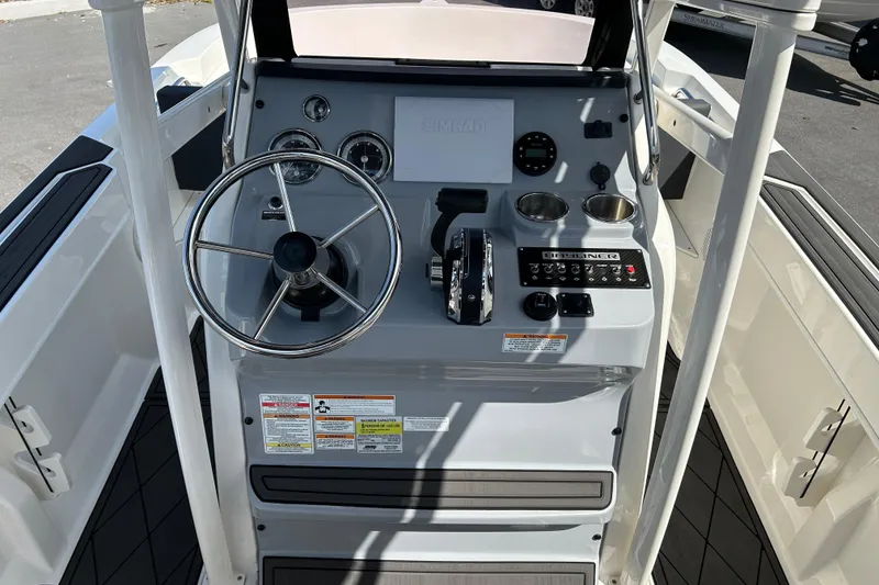 Slide: The Image of 2022 Bayliner Trophy T20CX boat console with steering wheel and controls. - 10