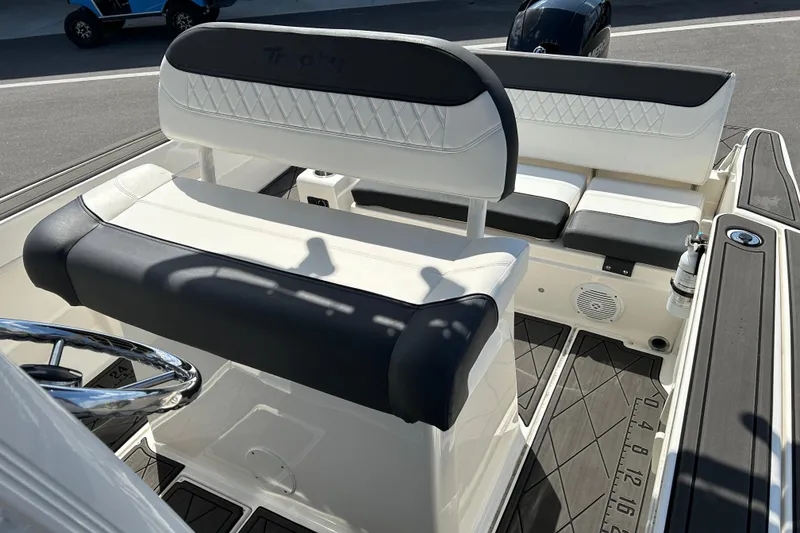 Slide: The Image of 2022 Bayliner Trophy T20CX boat interior with cushioned seating and steering wheel. - 11