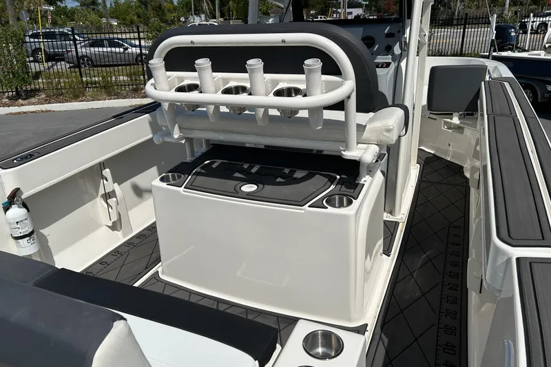 Slide: The Image of 2022 Bayliner Trophy T20CX boat interior with rod holders and seating. - 12