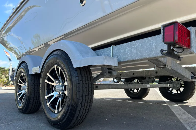 Slide: The Image of 2022 Bayliner Trophy T20CX boat on trailer with dual wheels and red taillight. - 19
