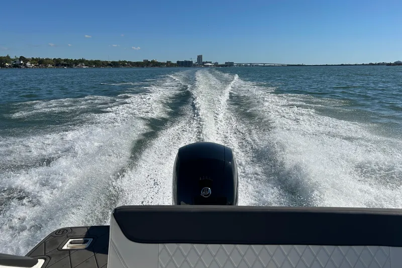 Slide: The Image of Bayliner Trophy T20CX 2022 boat cruising on open water, leaving a wake behind. - 22