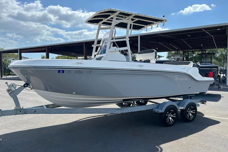 Slide: The Image of 2022 Bayliner Trophy T20CX boat on trailer under sunny sky. - 5
