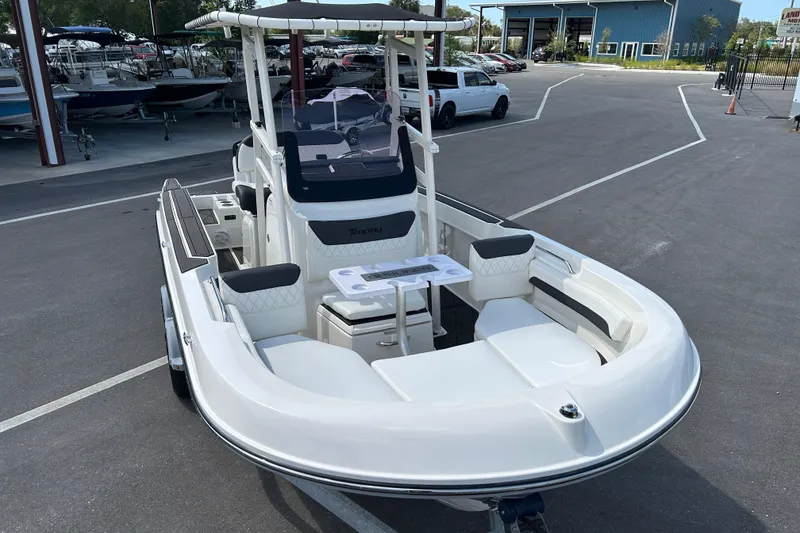 Slide: The Image of 2022 Bayliner Trophy T20CX boat with seating and console, parked in a marina. - 6