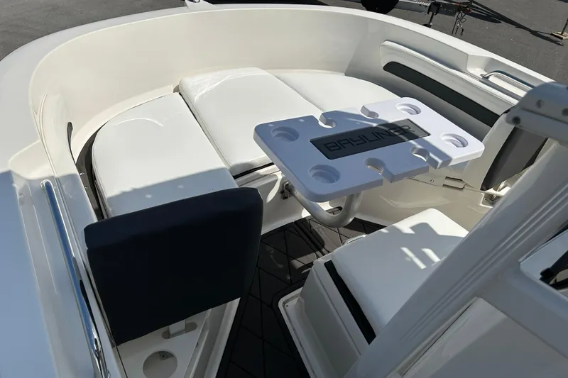 Slide: The Image of 2022 Bayliner Trophy T20CX boat interior with seating and table setup. - 8