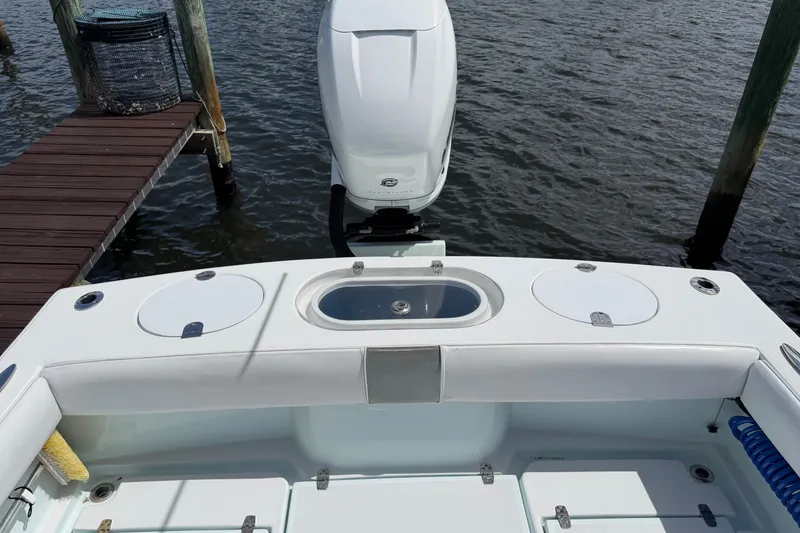 Slide: The Image of 2022 Latitude Tournament Boats 25 with outboard motor at dockside. - 10