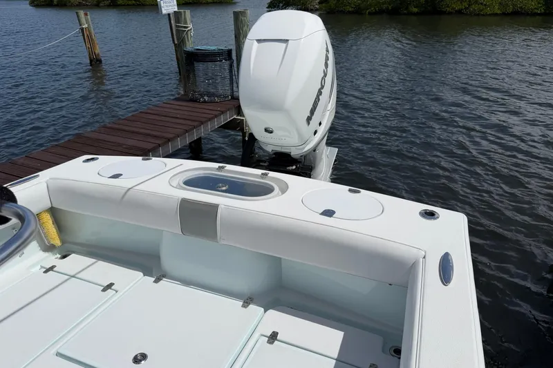 Slide: The Image of 2022 Latitude Tournament Boats 25 docked, featuring a powerful Mercury outboard engine. - 11