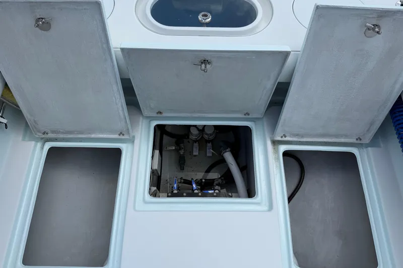 Slide: The Image of Open compartments on a 2022 Latitude Tournament Boats 25, revealing storage and mechanical areas. - 12