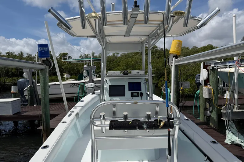 Slide: The Image of 2022 Latitude Tournament Boats 25 docked, featuring fishing rod holders and navigation equipment. - 4