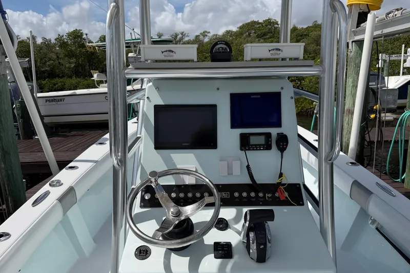 Slide: The Image of 2022 Latitude Tournament Boats 25 cockpit with steering wheel, navigation screens, and controls. - 5