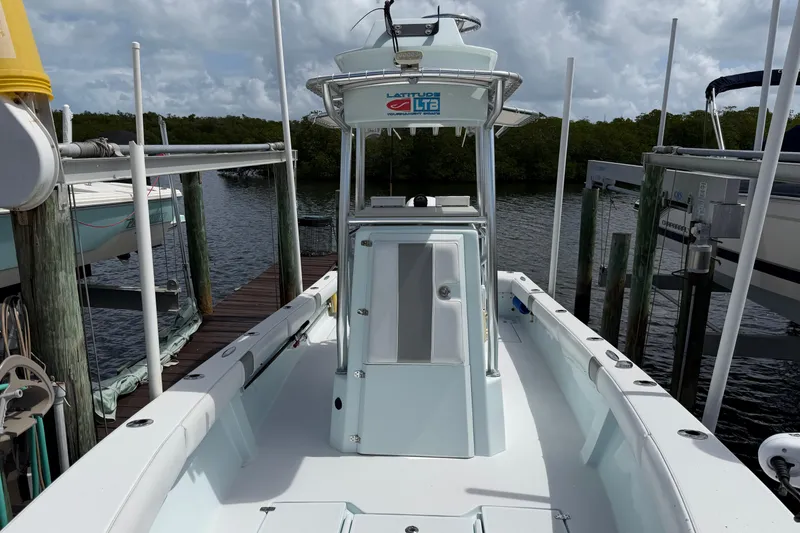 Slide: The Image of 2022 Latitude Tournament Boats 25 docked, showcasing sleek design and spacious deck. - 7