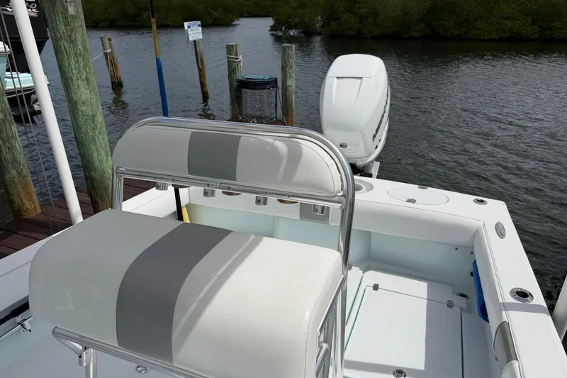 Slide: The Image of 2022 Latitude Tournament Boats 25 at dock, featuring seating and outboard motor. - 9