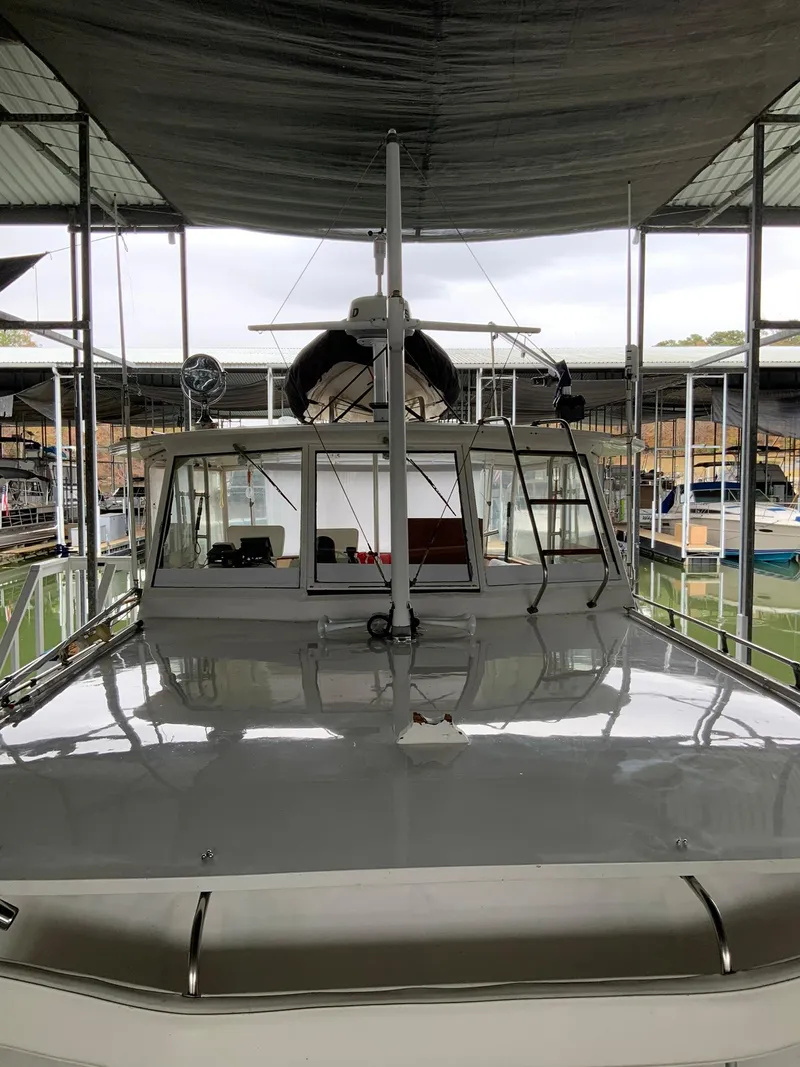 Slide: The Image of 1969 Hatteras 41 Double Cabin yacht docked under a covered marina. - 18