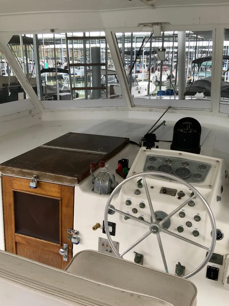 Slide: The Image of Helm of 1969 Hatteras 41 Double Cabin with steering wheel and control panel. - 26