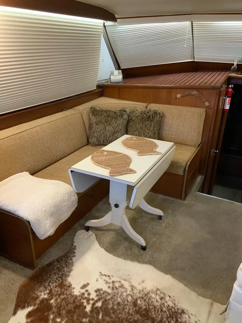 Slide: The Image of 1969 Hatteras 41 Double Cabin interior with cozy seating and foldable table. - 37