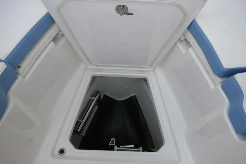 Slide: The Image of 2025 Robalo R360 Center Console storage compartment with blue seating. - 10