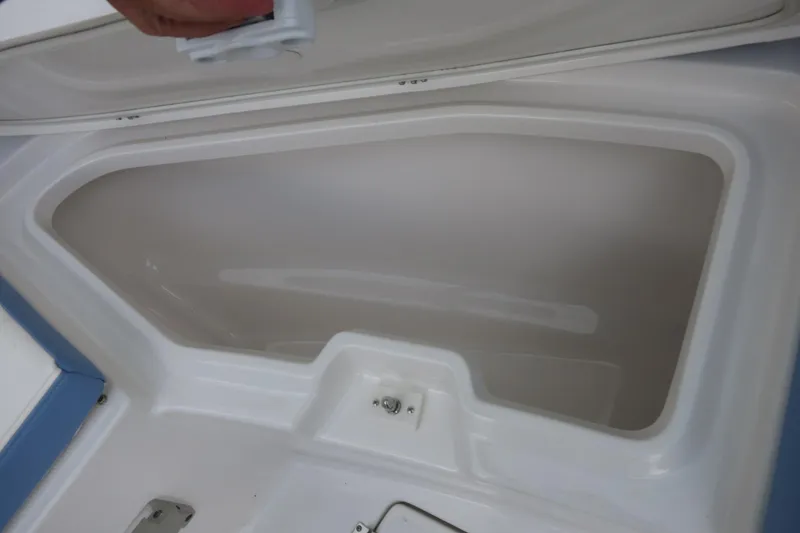 Slide: The Image of 2025 Robalo R360 Center Console storage compartment with open lid. - 13