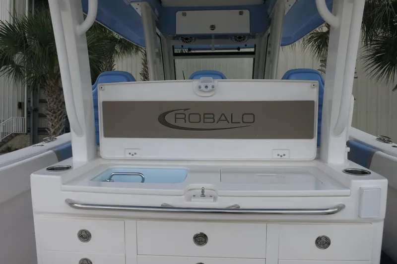 Slide: The Image of 2025 Robalo R360 Center Console boat interior with storage and sink. - 17