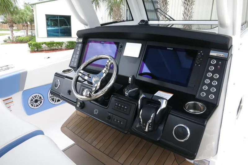 Slide: The Image of 2025 Robalo R360 Center Console helm with dual screens and modern controls. - 22