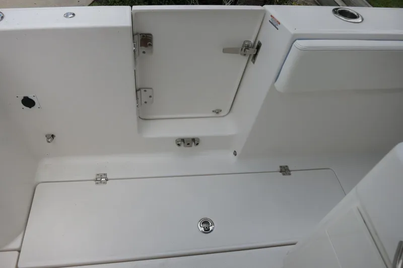 Slide: The Image of 2025 Robalo R360 Center Console boat interior, featuring storage compartments and sleek design. - 23