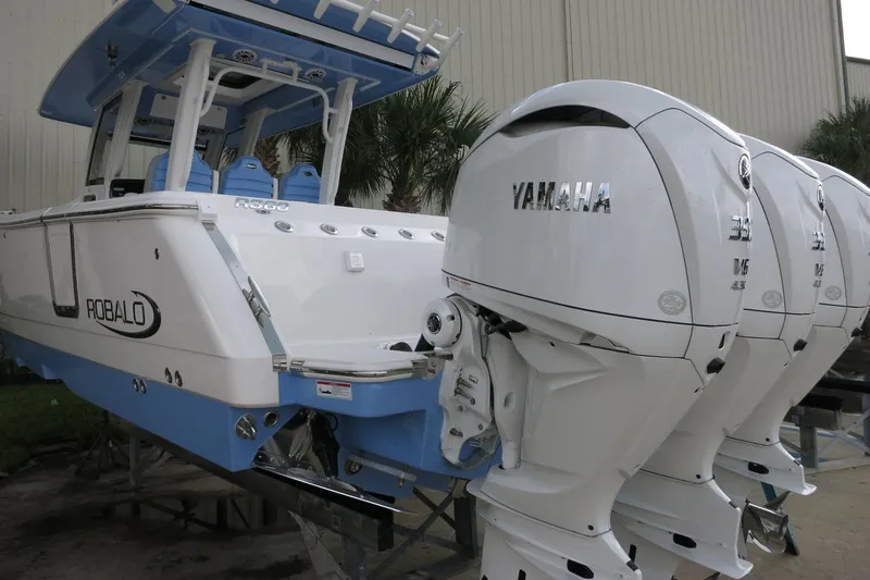 Slide: The Image of 2025 Robalo R360 Center Console boat with Yamaha outboard engines, docked outdoors. - 4