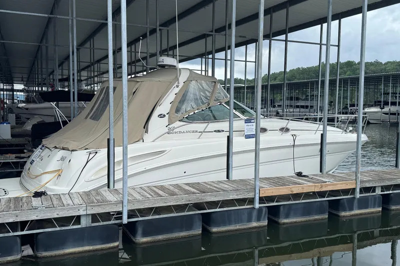 The Image of 2005 Sea Ray 360 Sundancer docked in a marina under a covered shelter. - 0