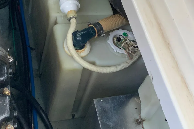 Slide: The Image of Engine compartment of 2000 Sea Ray Sundancer boat showing hoses and components. - 13
