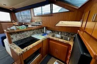 Slide: The Image of Interior of 1993 Mikelson 50 Sportfisher yacht with wood cabinetry and granite countertops. - 10