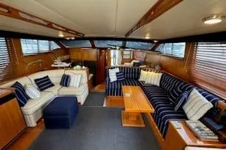 Slide: The Image of Luxurious interior of 1993 Mikelson 50 Sportfisher yacht with elegant seating and wooden accents. - 11