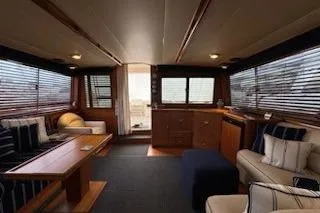 Slide: The Image of Luxurious interior of a 1993 Mikelson 50 Sportfisher yacht with elegant seating and wood finishes. - 12