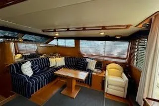Slide: The Image of Luxurious interior of a 1993 Mikelson 50 Sportfisher yacht with striped seating. - 13