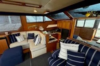 Slide: The Image of Interior of 1993 Mikelson 50 Sportfisher yacht with plush seating and nautical decor. - 15