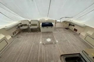 Slide: The Image of 1993 Mikelson 50 Sportfisher boat deck with seating and covered area. - 19